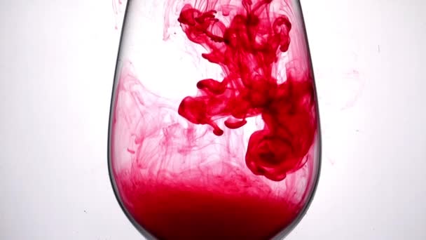 Aqua ink drops in wineglass — Stock Video