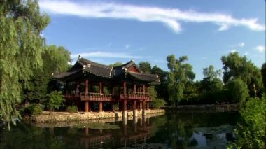 Geleneksel Kore Tapınağı suda ıslatın ve bulutlu mavi gökyüzü arka plan üzerinde yansıtan yapı