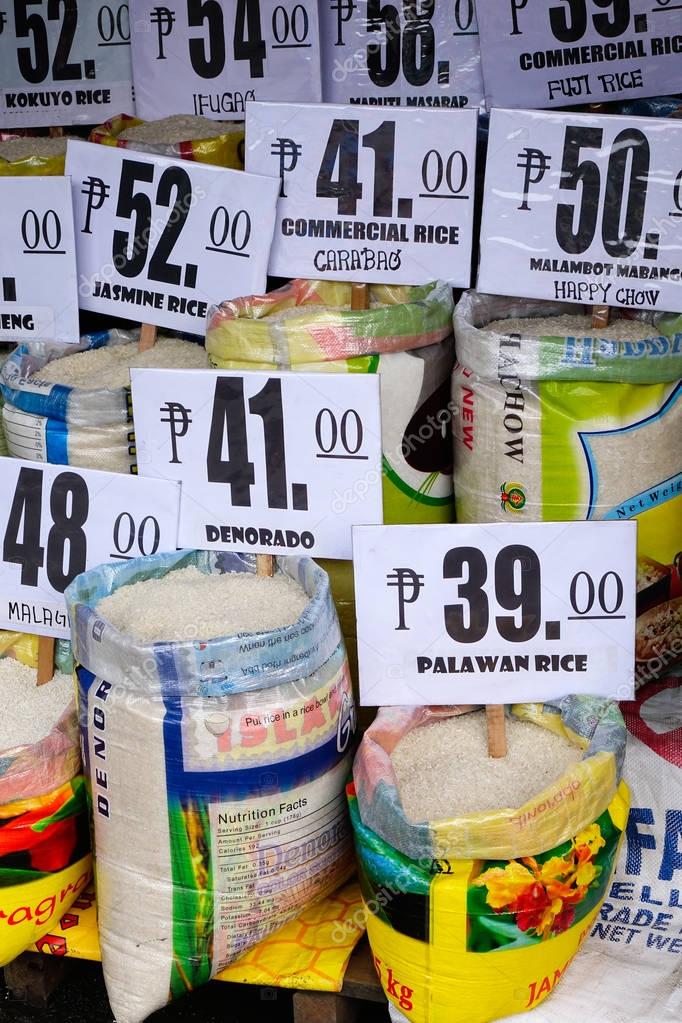 Many bags of rice in a local outdoor market Stock Editorial Photo