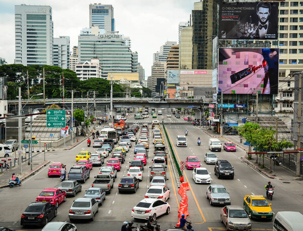 BANGKOK, THAILAND - JUL 31, 2015. Many cars running on a busy road in the city centre of Bangkok, Thailand. Bangkok is the capital and most populous city of Thailand.