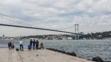 Körfez kıyısında dinlenen insanlar