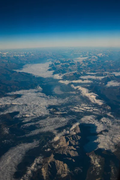 Luchtfoto boven de wolken op bergtoppen — Stockfoto