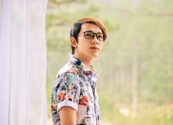 Asian handsome man standing on balcony — Stock Photo, Image