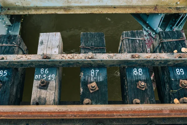 Detail of rusty screws and nut on old railroad track — Stock Photo, Image