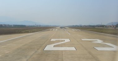 Empty runway of international airport in sunny day. clipart
