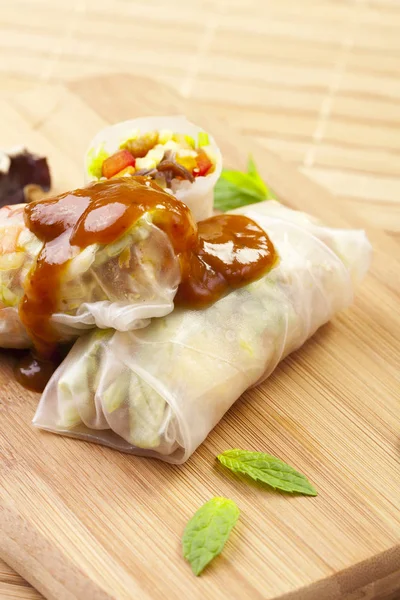 Portion of spring rolls on a bamboo board — Stock Photo, Image