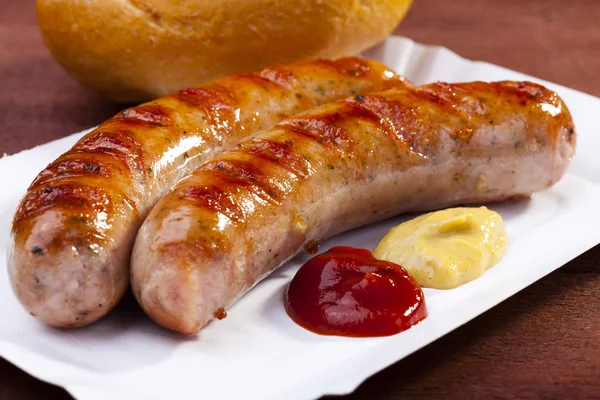 Roasted sausage with bread served on a paper tray — Stock Photo, Image