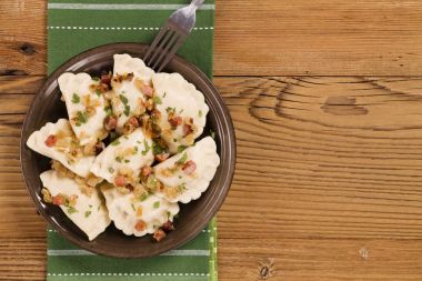 Delicious homemade dumplings with onion and bacon clipart
