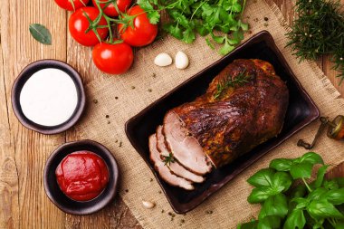 Domates soslu domuz rostosu, sarımsak ve bitkilerle sos..