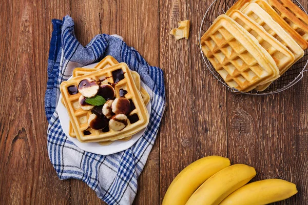 Delicious waffles with banana and chocolate