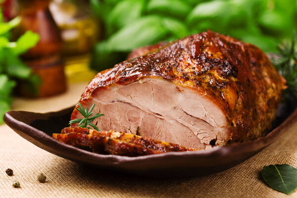 Roast pork with herbs and vegetables.