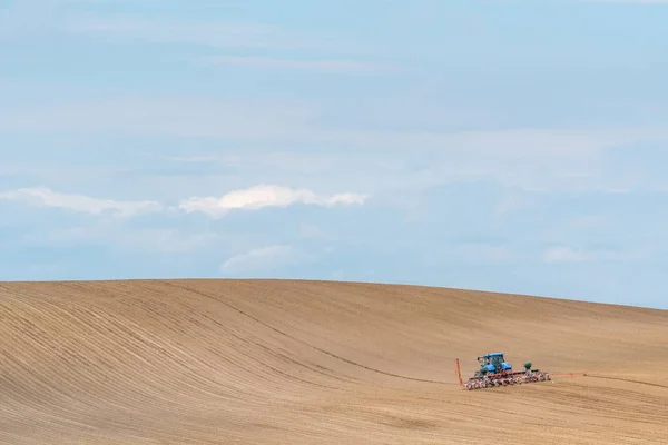 stock image Tractor harrowing the field