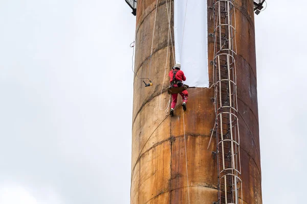 Workers climbing on the big chimney