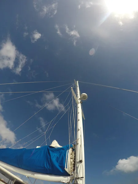 Sailboat sail detail over blue sky with bright sun — 스톡 사진