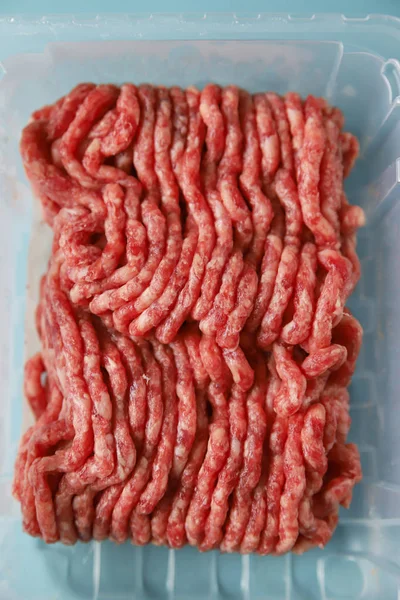 Ground beef in packing  natural or artificial cultured meat, close up