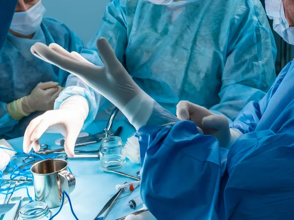 A group of surgeons performing minimally invasive surgery on the patients anus using surgical instruments. — Stockfoto