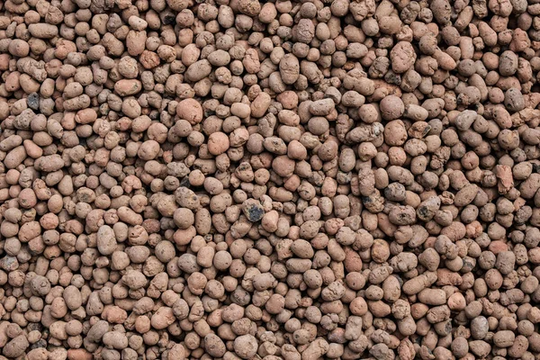 Flat lay. Top view on a seamless abstract background from expanded clay. Construction material. Clayd claydite granules as a drainage for plants. — Stock Image Flat Lay Top View Seamless Abstract Background Expanded Clay Construction Royalty Free Stock Images