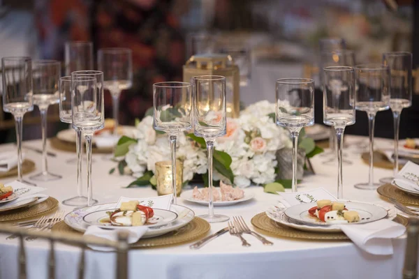 Elegant table set up for wedding reception with salads.