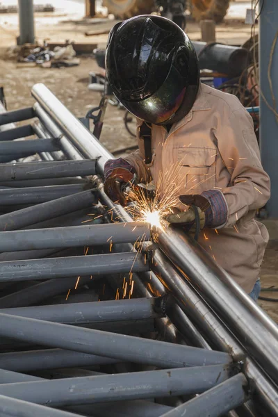 Worker without safety protective welding steel structure in construction factory, Use the wrong kind equipment and conditions hazardous working.