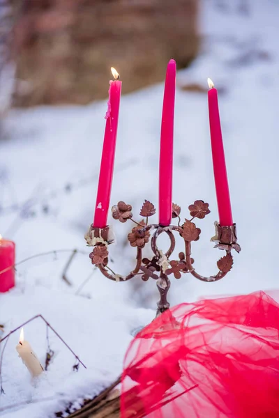 Burning candles stand in the snow — Stock Fotó