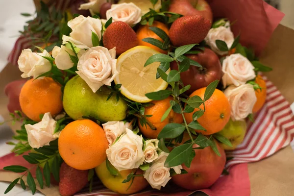 fruit and berry bouquet with roses in a package