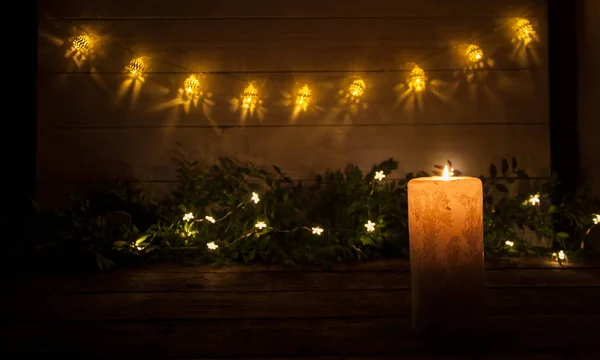 Large Candle Burns Dark Black Background Garland Lights Stars Christmas — Stock Photo, Image