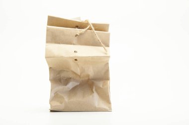 Gift paper parchment bag with bow and note. On white background