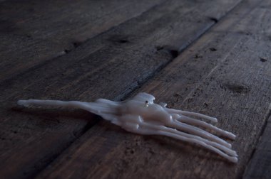 The rest of the melted candle on a wooden table. Love has melted. Darkness