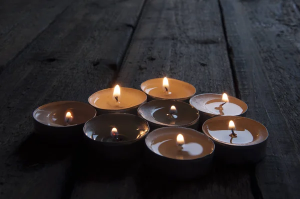 Lighted Small Candles Laid Out Row Wooden Table Texture Symbol — Stockfoto