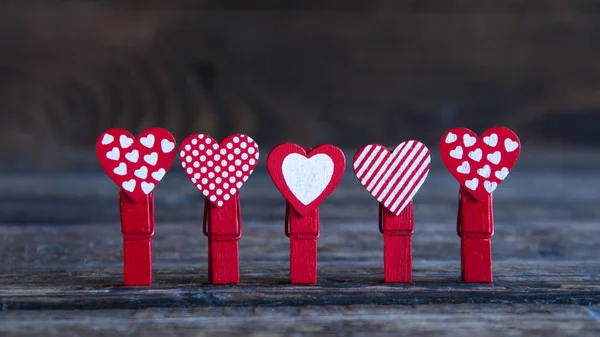 Lot Little Red Clothespins Hearts Wooden Background — Stock Photo, Image