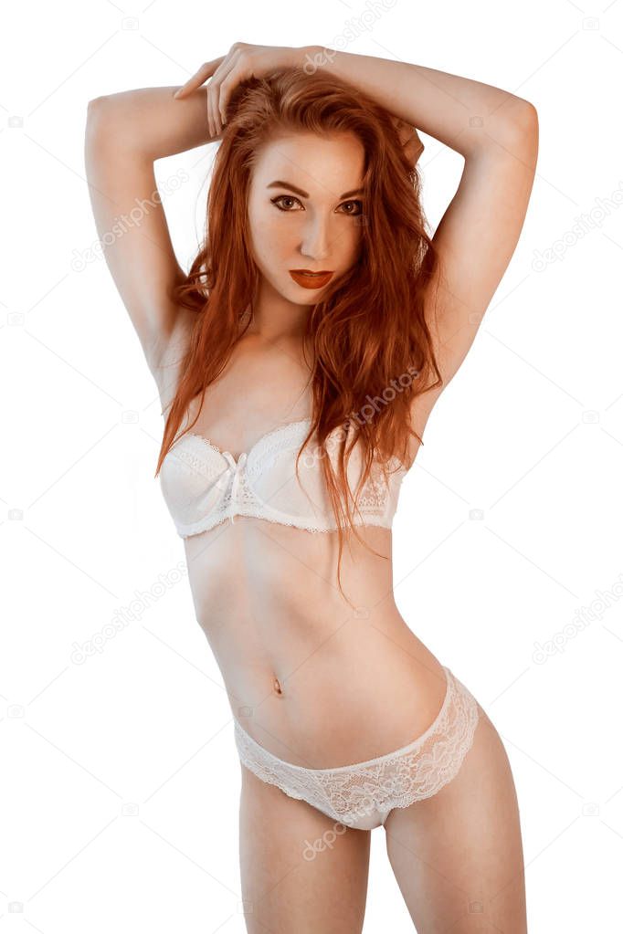 Attractive young haired woman in white lingerie posing