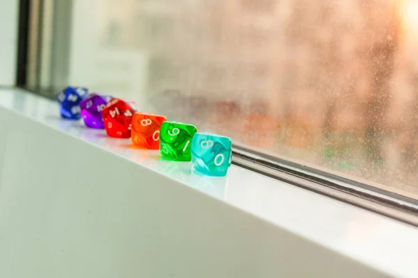 Different Dices for board games, near the window