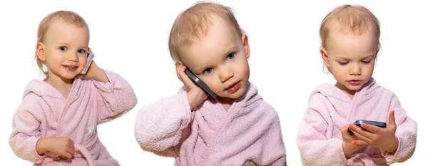 Two year old little girl using a smart phone on white background — Stock Photo, Image