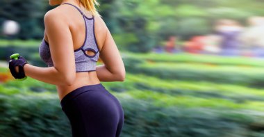 Eğitim kavramı, elinde dumbbells ile sokakta koşan genç kız. Gövde kapatın. Kopya alanı