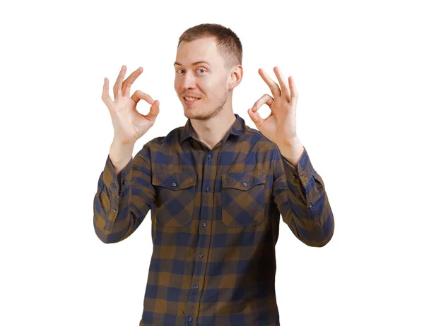 A nice young man wearing green checkered shirt shows Ok symbol. Isolated on white background. — Stock Photo, Image