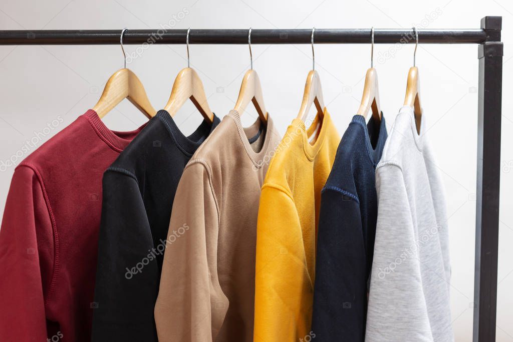Blank sweatshirts hanging on a hanger in the wardrobe or showroom