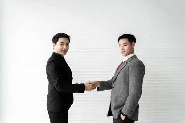 Business deal / two businessman handshake on white background / business concept /asian model