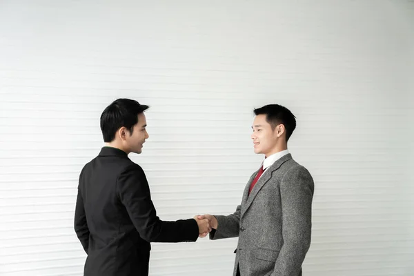 Business deal / two businessman handshake on white background / business concept /asian model