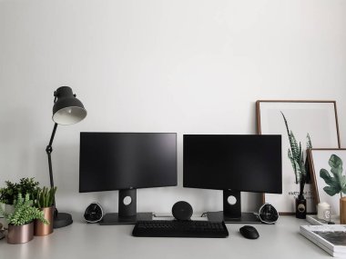 Bangkok, Thailand - March 12, 2020: Working from home studio to self-quarantine by desktop computer with two monitors and nice decoration design /home workplace / protect outbreak