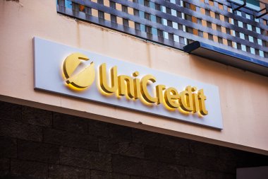 Castelmola, SICILY, ITALY - SEPTEMBER 26, 2019: Unicredit logo on the facade of the office in the city of Castelmola in Italy Sicily clipart