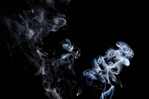 Smoke on a black background, abstract photo with swirls in the air