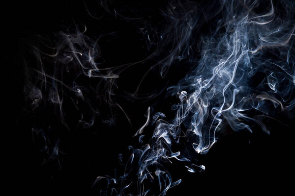 Smoke on a black background, abstract photo with swirls in the air