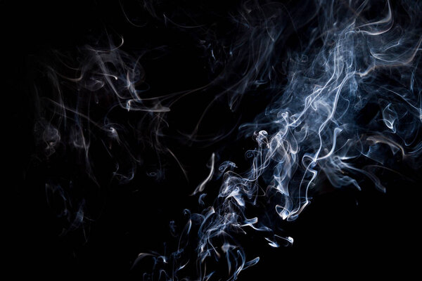 Smoke  on a black background, abstract photo with swirls in the air