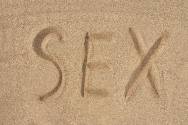 The inscription sex on the sea sand