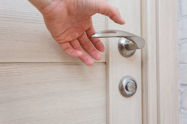 things and objects in everyday life and human life through which germs and viruses spread, door handle in an apartment in a room or house with hand and finger