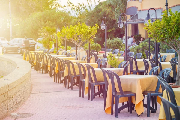 empty street cafe or restaurant in Italy in Sicily in the city of Giardini Naxos, toned sunrise