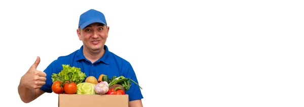 Cheerful Delivery Man Fresh Vegetables Blue Uniform White Background Pointing — Stock Photo, Image