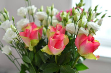 Beautiful Eustoma and Roses flowers, white eustoma on white background.Wedding invitation in minimalist style with eustoma. Template for greeting wedding or spring card. Copy space. Mother's day card