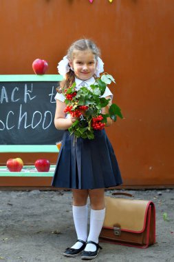 Portrait of beautiful young first-grader Farewell Bell. day of knowledge. beginning of the school year. Girl with books. day of knowledge. beginning of the school year. school equipment. clipart