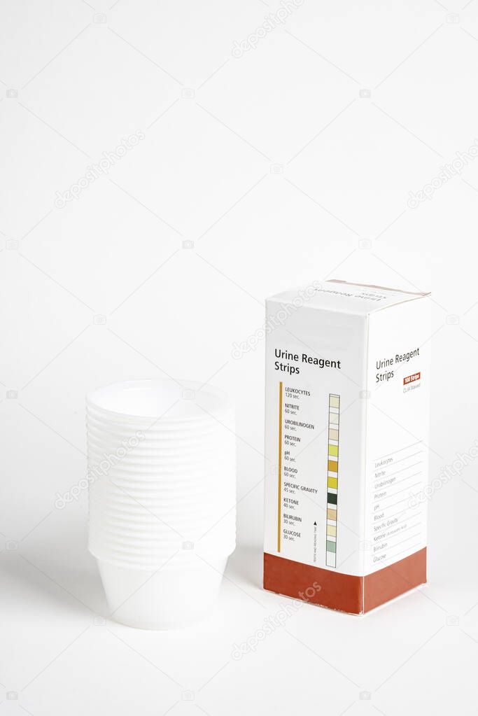 Urine Strips Box And A Stack Of Plastic Containers